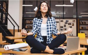 woman meditating on a desk